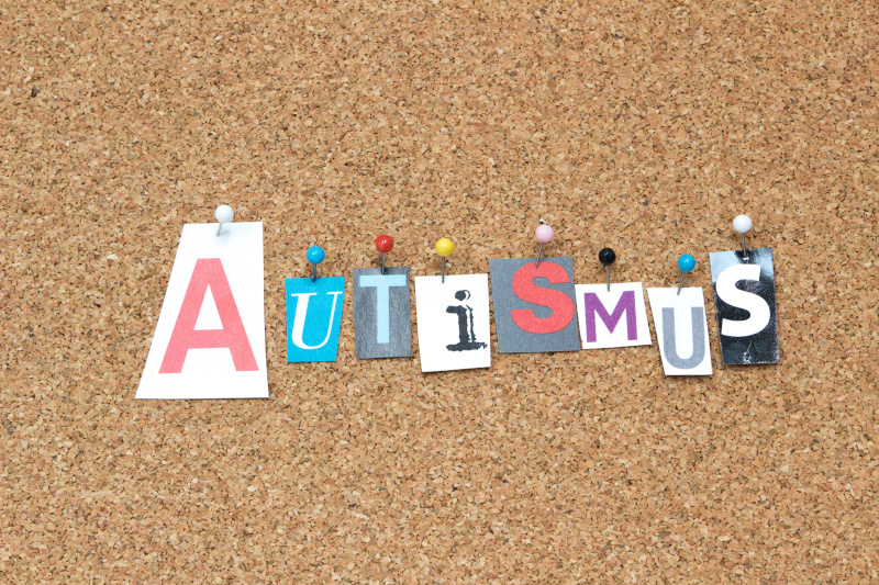 Eine Korktafel, auf der das Wort Autismus angepinnt ist.